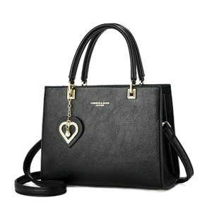 Chic black lychee leather tote bag with heart charm and adjustable strap for women