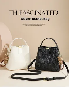 Detailed view of woven bucket bags in black and white with cute bear charm and gold hardware