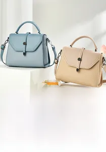Detail of woven and smooth faux leather textures with round metal buckle on handbags
