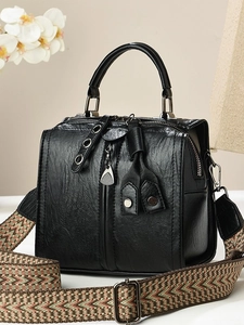 Black vintage boston bag with woven wide shoulder strap and textured leather finish