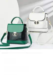 Detail view of stylish color-block crossbody bags with glossy finish and metal clasps