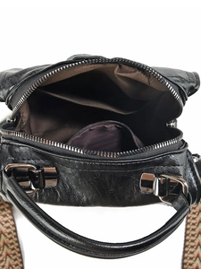 Retro black pillow bag with textured leather and colorful woven shoulder strap