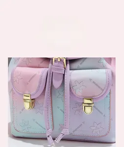 Detail of pink and blue gradient soft leather backpack featuring dual front buckled pockets