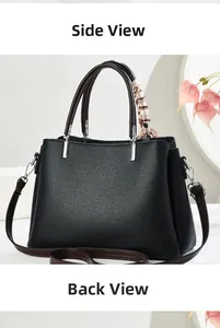 Dettaglio borsa nera in pelle a grana con manico marrone e foulard decorativo in seta
