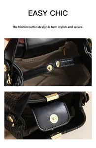 Detail of the magnetic snap closure on a black woven bucket bag with gold hardware