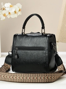 Black vintage Boston pillow bag with stylish jacquard woven wide strap and textured leather
