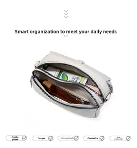 Overhead view showing multiple compartments and interior storage of the white crossbody bag