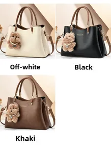 Detailed view of leather handbags in beige, black, and khaki with cute teddy bear pendants