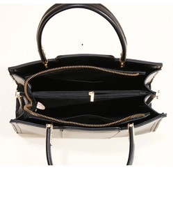 Internal view of the black leather handbag showing compartments and golden hardware