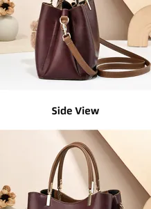 Side view and handle detail of a wine red lychee pattern leather bucket handbag for women