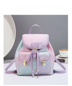 Chic gradient pink and blue backpack featuring cherry blossom prints and golden buckles