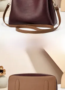 Detail of the burgundy and brown color-block handbag showing the back view and bottom stitching