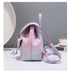 Detail of a purple gradient leather backpack with floral patterns and gold hardware