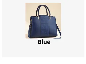 Detailed view of dark blue leather handbag featuring elegant rose embossing and gold hardware
