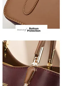 Macro shot of bottom protective studs and golden metal buckles on two-tone handbag