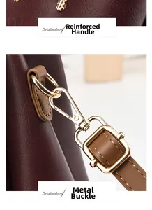 Close-up of burgundy leather handbag showing reinforced handle and gold metal swivel hook