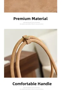 Close-up of premium tan suede texture and reinforced handle with gold metal buckles