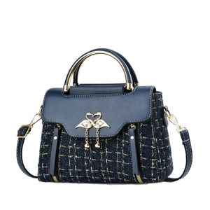 Navy blue tweed and leather handbag with golden swan buckle and circular metal handle