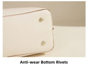 Detail of the handbag bottom with protective gold studs and brown edge painting