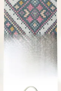 Detail of pixel style jacquard fabric with colorful diamond pattern and round white handle