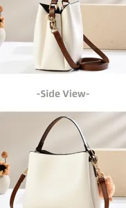 Side view detail of beige leather bucket bag with brown handle and plush charm