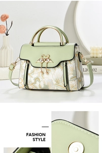 Close-up of floral pattern handbag with swan metal buckle and elegant pearl pendant