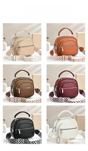 Detailed grid of faux leather handbags with wide geometric patterned straps in six colors