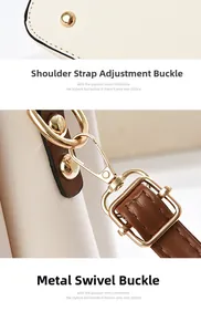 Detail of adjustable strap buckle and gold lobster clasp on beige leather bucket bag