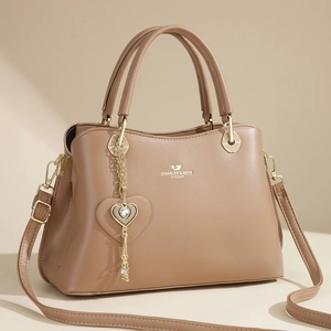 Caramel brown large tote bag for women featuring a gold logo and heart pendant charm