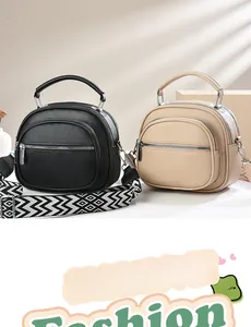 Detail of minimalist pebble leather crossbody bags with adjustable geometric straps