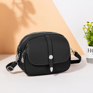 Classic black leather crossbody bag with three-tier zippers and silver metallic studs