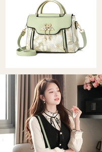 Detail view of floral print leather handbag with golden swan buckle and pearl pendant