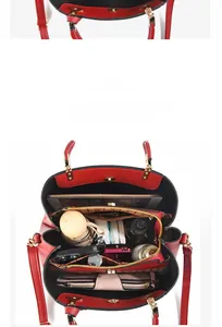 Internal view of red leather handbag showing multi-compartment storage capacity