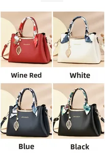 Detailed view of structured leather tote bags in four colors with silk scarves and charms