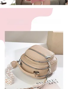 Detail of beige faux leather crossbody bag with ethnic wide strap and triple zippers