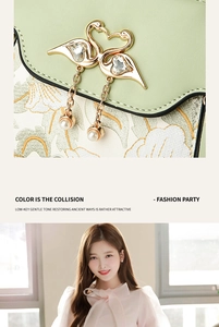 Detail of mint green leather handbag featuring golden swan lock with pearls and crystals