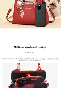 Detail of red bridal tote bag featuring multi-compartment interior and gold hardware
