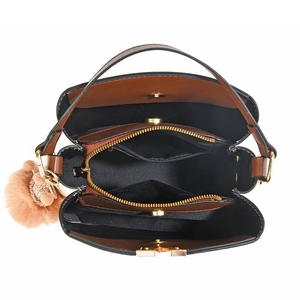 Contrast color bucket bag with multiple inner compartments and plush ball charm accessory