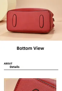 Detail view of the reinforced bottom base of red lychee grain leather handbag