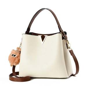 Chic cream white PU leather bucket bag with brown handles and a cute plush charm