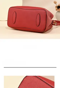 Detail of red bridal tote bag featuring premium lychee grain leather texture and base