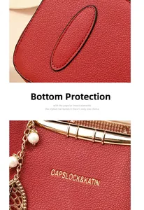 Close-up of red leather tote base and golden logo with decorative pearl leaf charm