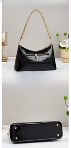 Detailed views of glossy crocodile pattern handbag with golden chain and bottom studs