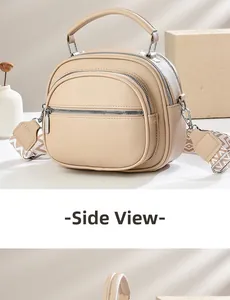 Side view of beige lychee texture bag with multi-zipper compartments and patterned strap