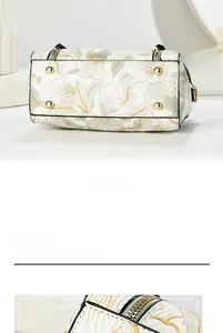 Detail of floral handbag with gold bottom studs and elegant metal zipper closure