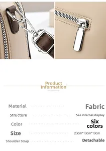 Detail view of silver hardware and size specs for the beige fabric crossbody bag