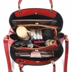 Large red textured leather handbag with spacious interior compartments and shoulder strap