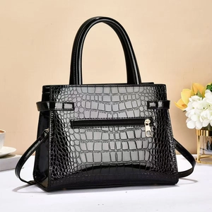 Polished black crocodile embossed tote bag with silver hardware and shoulder strap