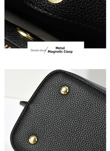 Détails du cuir grainé noir avec fermoir magnétique doré et pieds de protection en métal