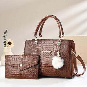Detail of caramel brown faux crocodile leather tote bag and envelope clutch set